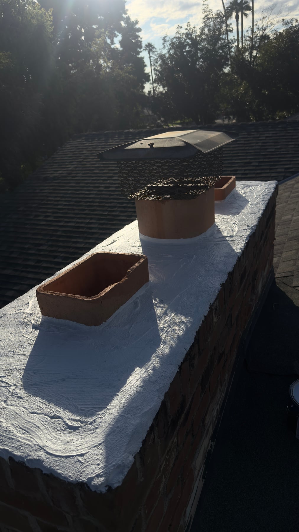 Arizona chimney chase with plywood top and open flue during repair work