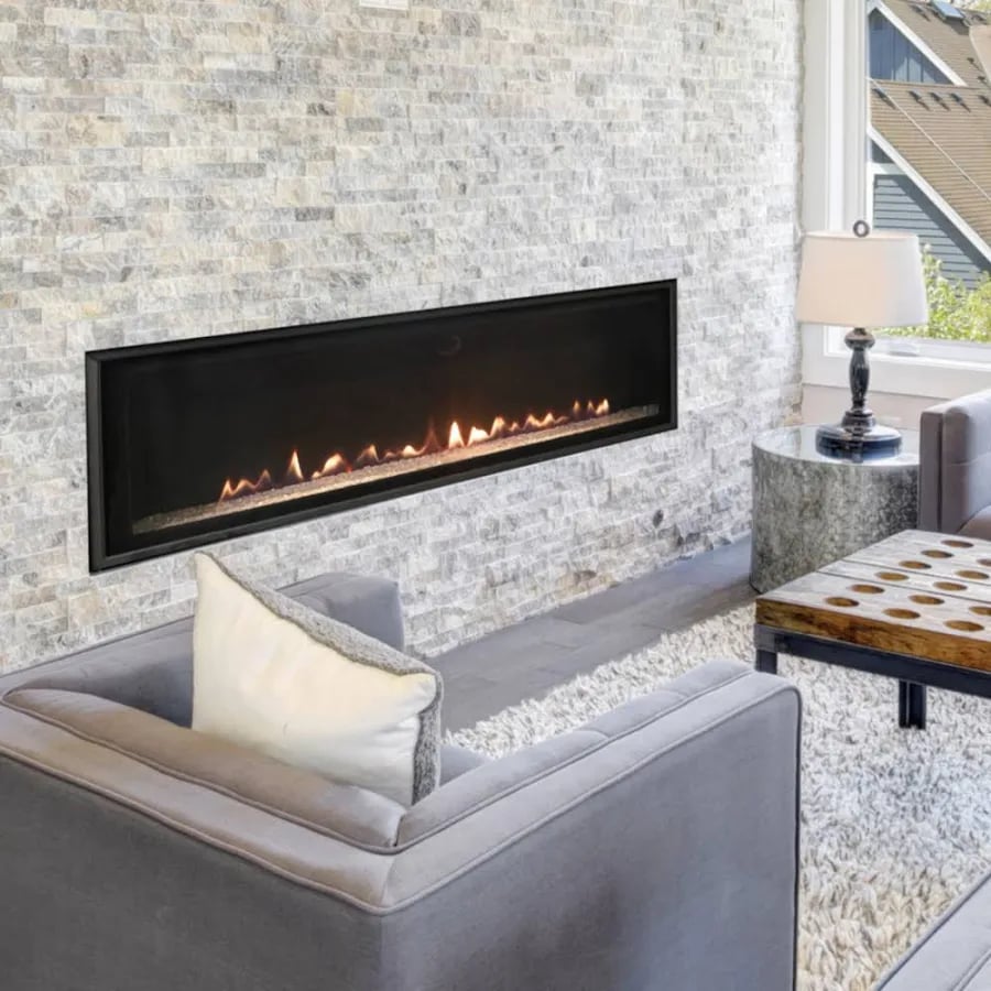 Modern gas fireplace with log set installed in white brick surround with white mantel
