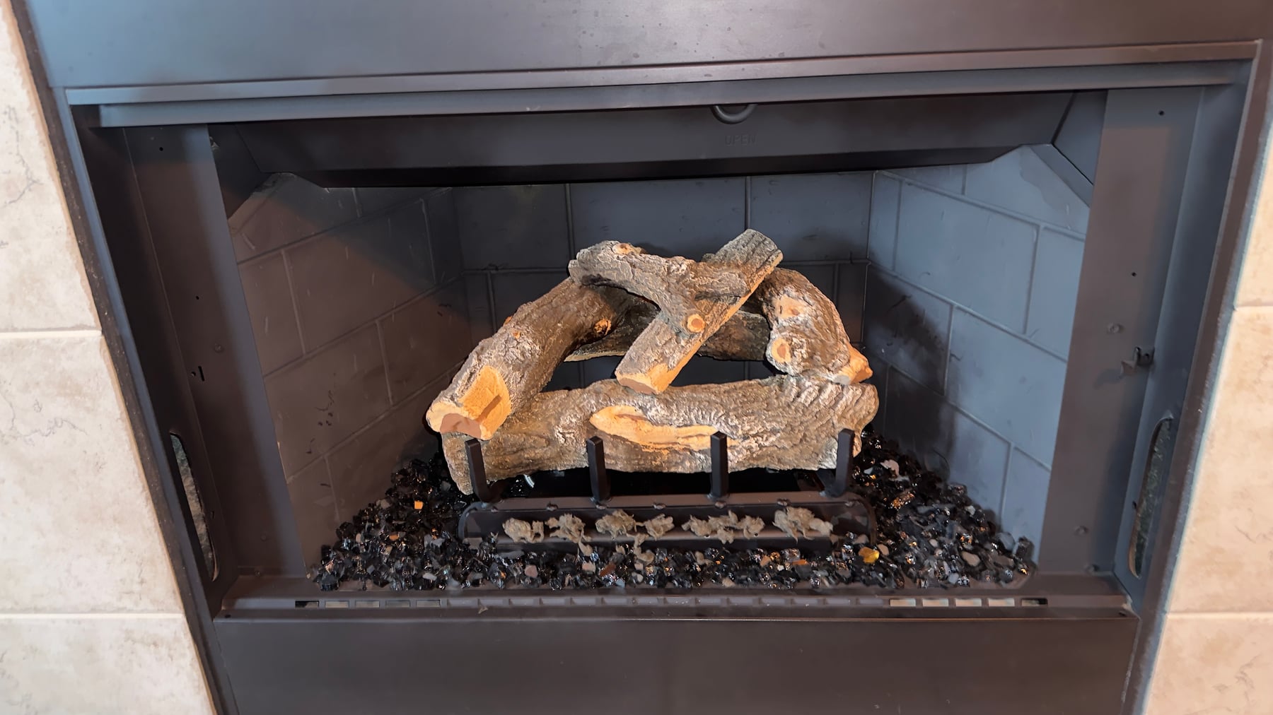 Ceramic gas logs with black glass media installed in an Arizona gas fireplace